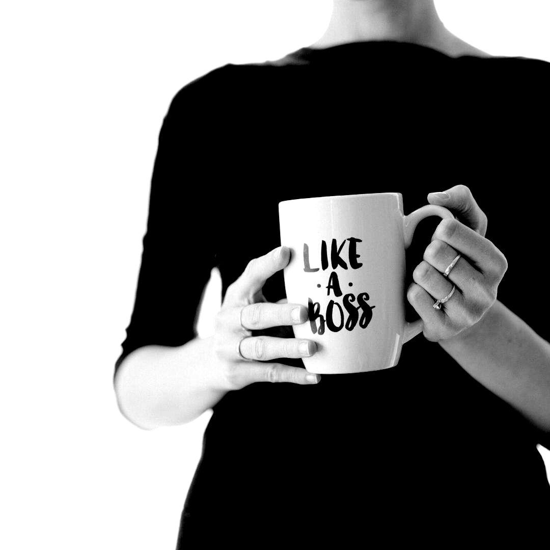 A woman holding a mug that says "Like a boss"